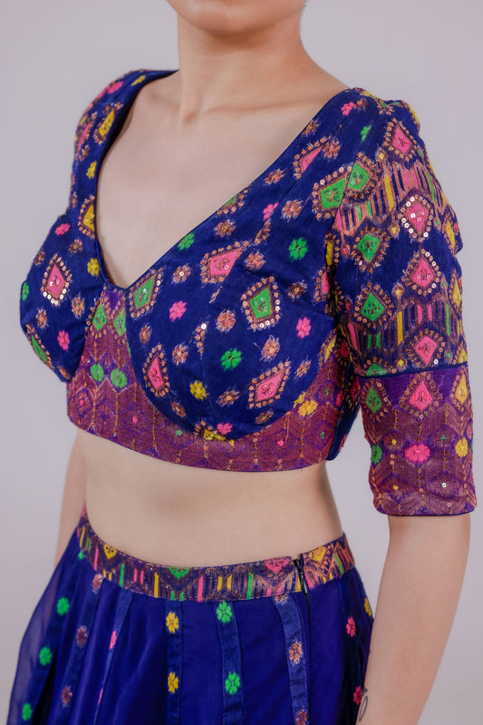 Traditional patterned blouse with colorful design on a plain background
